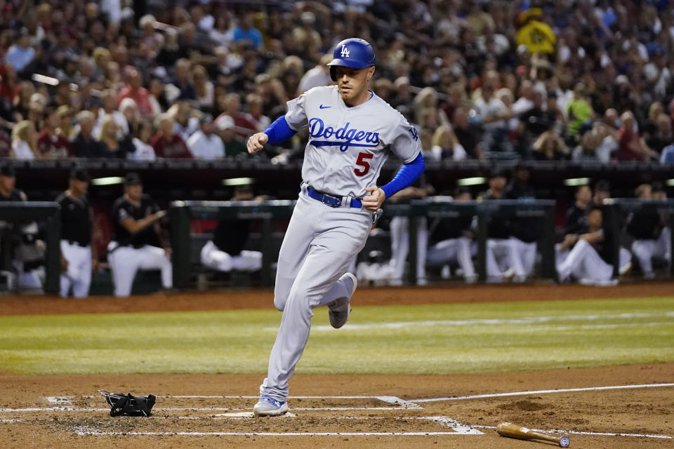 Los Angeles Dodgers' Freddie Freeman scores against the Arizona Diamondbacks during the third inning of a baseball game Thursday, April 6, 2023, in Phoenix. (AP Photo/Ross D. Franklin)