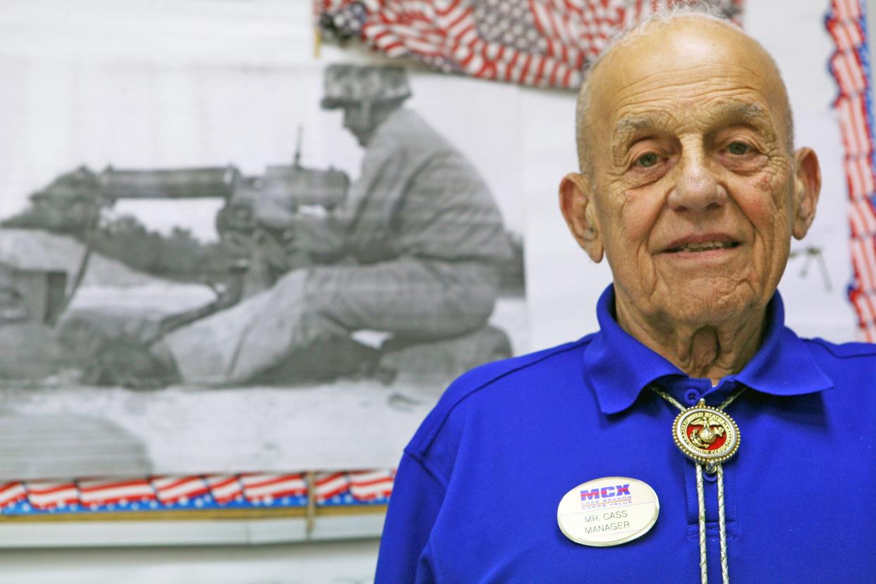 Retired Sgt. Maj. Marion P. Carcirieri stands in front of a photograph of himself at Camp Geiger Marine Mart, August 2013. Carcirieri fought at the Battle of Okinawa, in the Korean War and in the Vietnam War during his 31-year Marine Corps career.