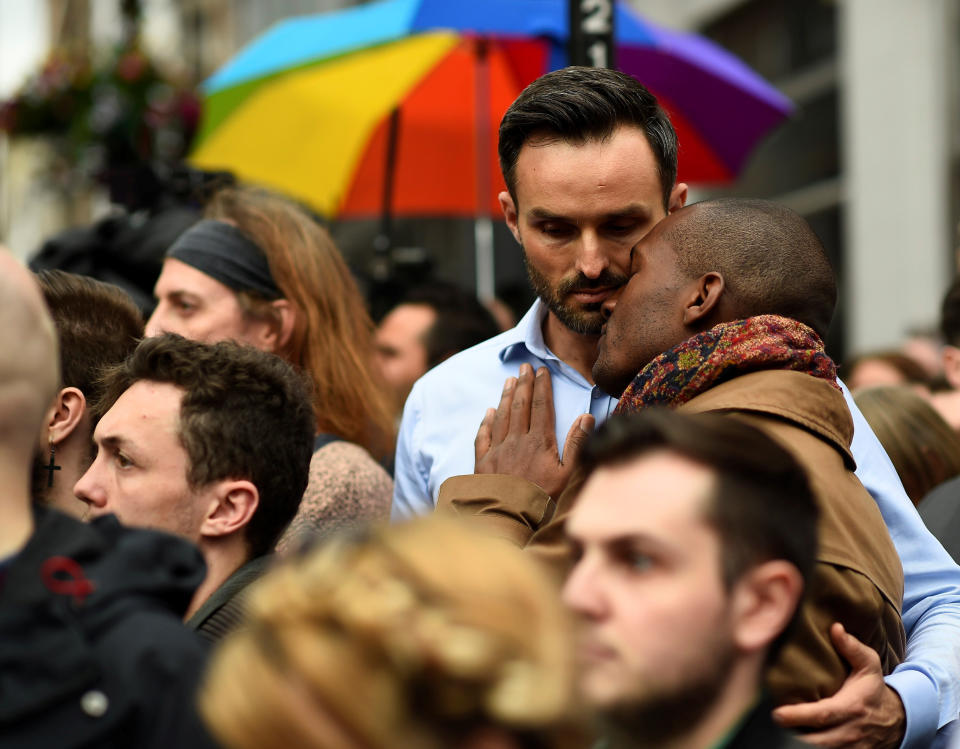 Men embrace during a minute's silence in memory of the victims of the gay nightclub mass shooting in Orlando, in the Soho district of London, June 13, 2016.&nbsp;