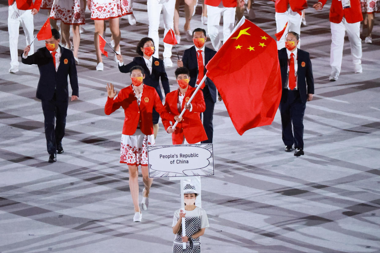 TOKYO, JAPAN - JULY 23: Flag bearers Zhu Ting and Zhao Shuai of Team China take part in the Parade of Nations during the Opening Ceremony of the Tokyo 2020 Olympic Games at Olympic Stadium on July 23, 2021 in Tokyo, Japan. (Photo by Lu Lin/CHINASPORTS/VCG via Getty Images)