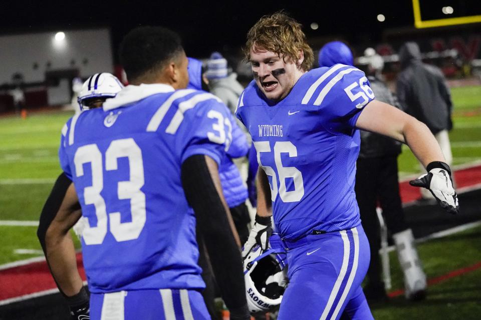 Wyoming offensive lineman Jess Hauer (56) celebrates with teammate Wyoming running back C.J. Hester (33) after Hester scored a touchdown during the second half of an OHSAA Division IV high school football regional semifinal against Clinton-Massie at Lakota West High School, Saturday, Nov. 12, 2022.