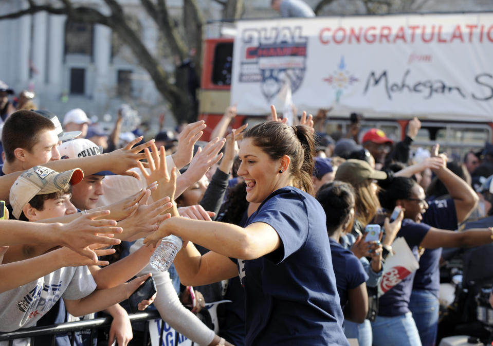 Connecticut's Stefanie Dolson interacts with with fans after a parade in Hartford, Conn., on Sunday, April 13, 2014, celebrating her team's recent NCAA national basketball championship. (AP Photo/Fred Beckham)