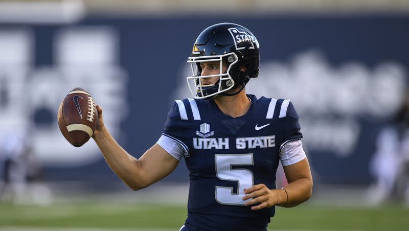 Utah State quarterback Cooper Legas (5) looks to hand the football back to the referee after a play during an NCAA football game on Oct. 7, 2023 in Logan, Utah.