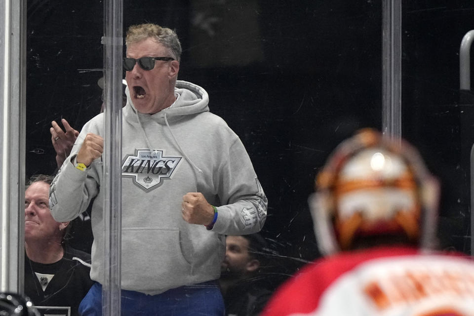 Actor Will Ferrell, left, cheers as Calgary Flames goaltender Jacob Markstrom watches during the second period of an NHL hockey game between the Los Angeles Kings and the Flames Thursday, April 11, 2024, in Los Angeles. (AP Photo/Mark J. Terrill)