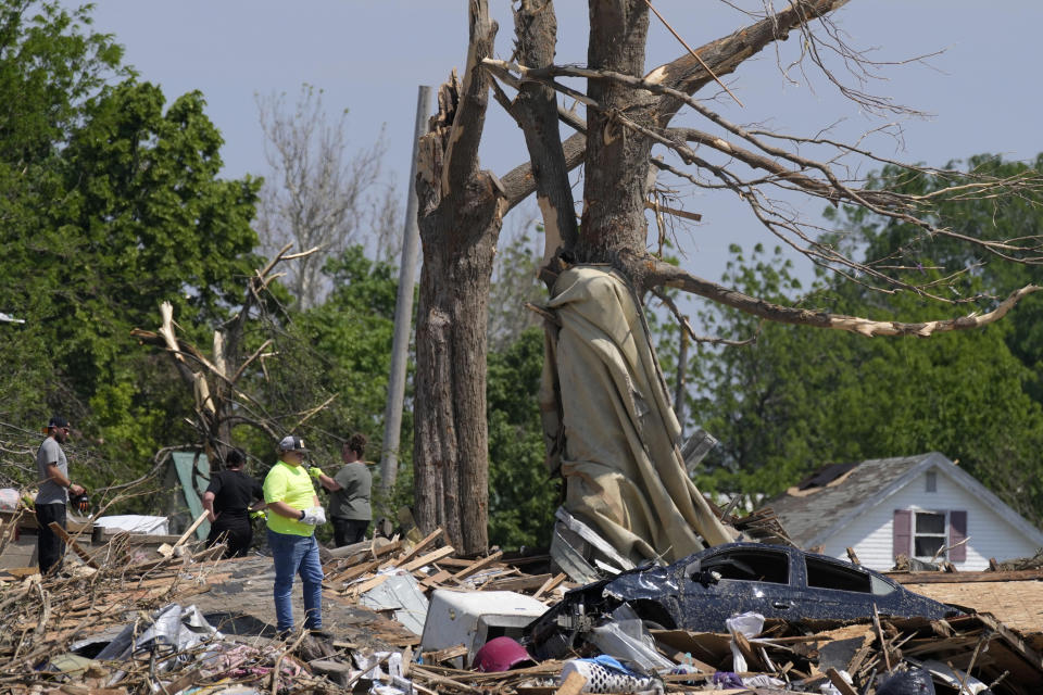 Workers survey the damage of a tornado damaged home, Wednesday, May 22, 2024, in Greenfield, Iowa. (AP Photo/Charlie Neibergall)