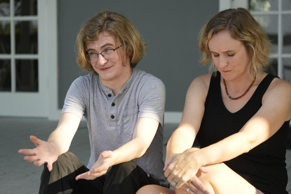 Ray Walker, 17, speaks about his need to move to Virginia for continued gender-affirming care and the effects on his family, while his mother Katie Rives, gathers her thoughts, Wednesday, June 28, 2023, in Madison County, Miss. This year, Republican Gov. Tate Reeves signed legislation banning gender-affirming care for anyone younger than 18. (AP Photo/Rogelio V. Solis)