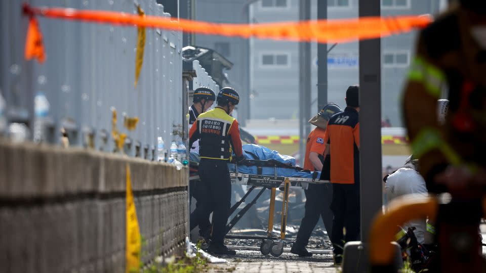 Emergency personnel carry the body of a person killed in a fire at a lithium battery factory owned by South Korean battery maker Aricell on June 24, 2024. - Kim Hong-Ji/Reuters