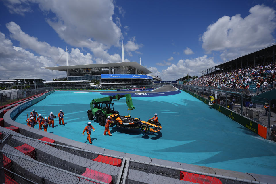 The car of McLaren driver Lando Norris of Britain is removed from the course by intervention marshals during the Sprint race at the Formula One Miami Grand Prix auto race, Saturday, May 4, 2024, in Miami Gardens, Fla. (AP Photo/Rebecca Blackwell)