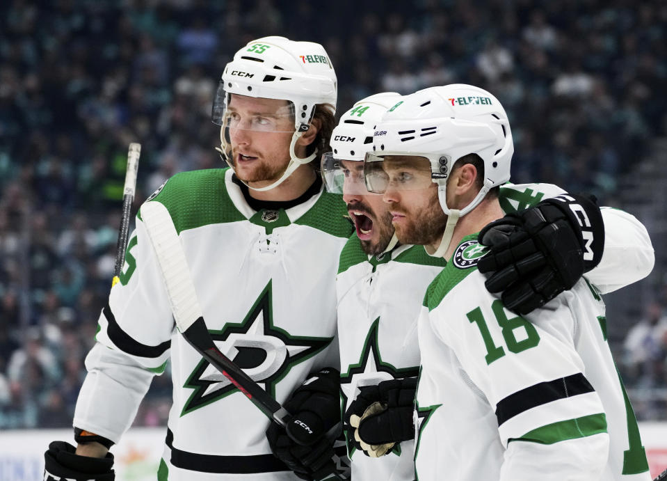 Dallas Stars defensemen Thomas Harley (55) and Joel Hanley (44) celebrate with center Max Domi (18) after Domi scored against the Seattle Kraken during the second period of Game 4 of an NHL hockey Stanley Cup second-round playoff series Tuesday, May 9, 2023, in Seattle. (AP Photo/Lindsey Wasson)