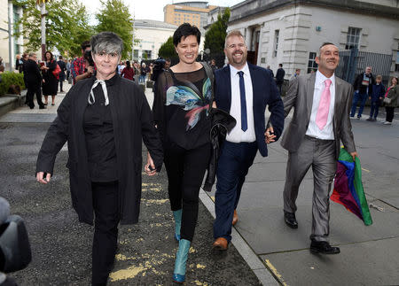 Henry and Christopher Flanagan-Kane with Shannon Sickles and Grainne Close depart the High Court in Belfast, Northern Ireland August 17, 2017. REUTERS/Michael Cooper