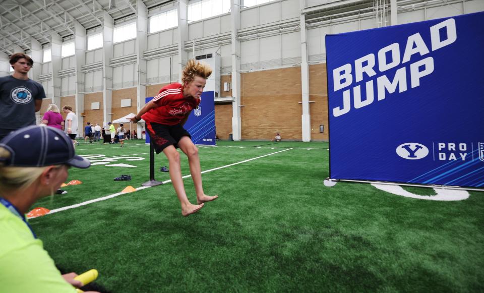 Joshua Nelson does his best in the broad jump as BYU holds a party to celebrate their move into the Big 12 Conference with music, games and sports exhibits in Provo on Saturday, July 1, 2023. | Scott G Winterton, Deseret News