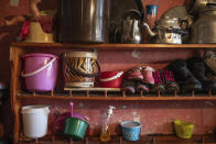 In this in Wednesday, March 25, 2020 photo, kitchen utensils and shoes placed on a shelf inside a room that's part of an overcrowded housing complex in Sale, near Rabat, Morocco. (AP Photo/Mosa'ab Elshamy)