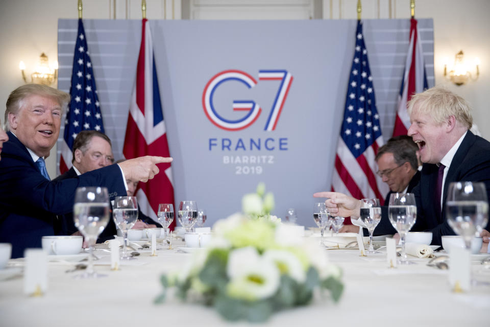 FILE - In this Aug. 25, 2019 file photo U.S. President Donald Trump, left, and Britain's Prime Minister Boris Johnson attend a working breakfast at the Hotel du Palais on the sidelines of the G-7 summit in Biarritz, France. British Prime Minister Boris Johnson has said a lot of nice things about Donald Trump over the years, from expressing admiration for the U.S. president to suggesting he might be worthy of the Nobel Peace Prize. But after a mob of Trump supporters invaded the U.S. Capitol on Jan. 6, Johnson has changed his tune.(AP Photo/Andrew Harnik, File)