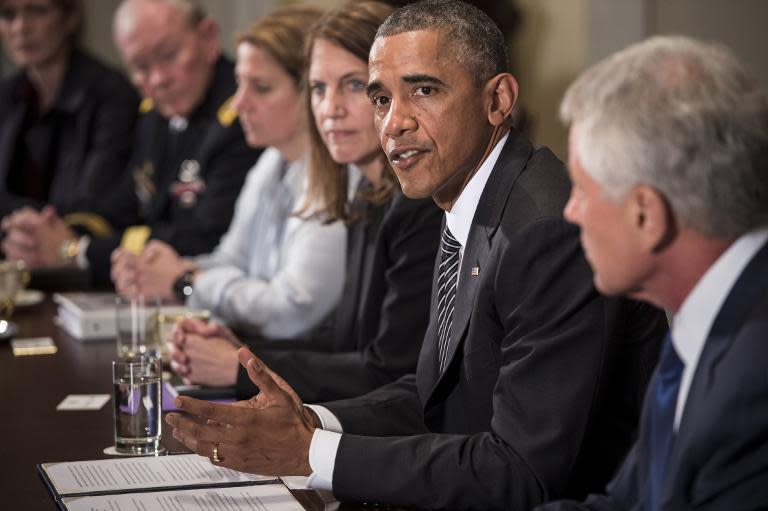 US President Barack Obama makes a statement for the press after a meeting in the Cabinet Room of the White House on October 15, 2014 in Washington, DC