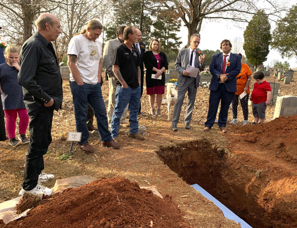 Family and friends gather for a funeral for Alabama death row inmate Doyle Lee Hamm at a cemetery in Cherokee, Ala., on Friday, Dec. 3, 2021. Hamm survived an execution attempt in 2018 and died years later of natural causes. He was laid to rest in a grave dug by family and friends, his lawyer said. (Fonda Shen via AP)