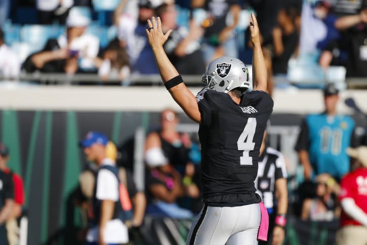 Oct 23, 2016; Jacksonville, FL, USA; Oakland Raiders quarterback Derek Carr (4) reacts after a touchdown in the second half against the Jacksonville Jaguars at EverBank Field. Oakland Raiders won 33-16. Mandatory Credit: Logan Bowles-USA TODAY Sports
