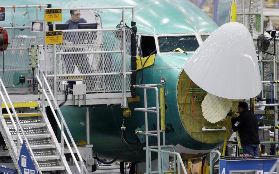 Workers assemble a Boeing Co. next-generation 737 airplane, Tuesday, Jan. 29, 2013 at the company's 737 assembly facility in Renton, Wash. On Jan. 25, 2013, Boeing began assembling next-generation 737 passenger airplanes at an increased rate of 38 planes per month. (AP Photo/Ted S. Warren)