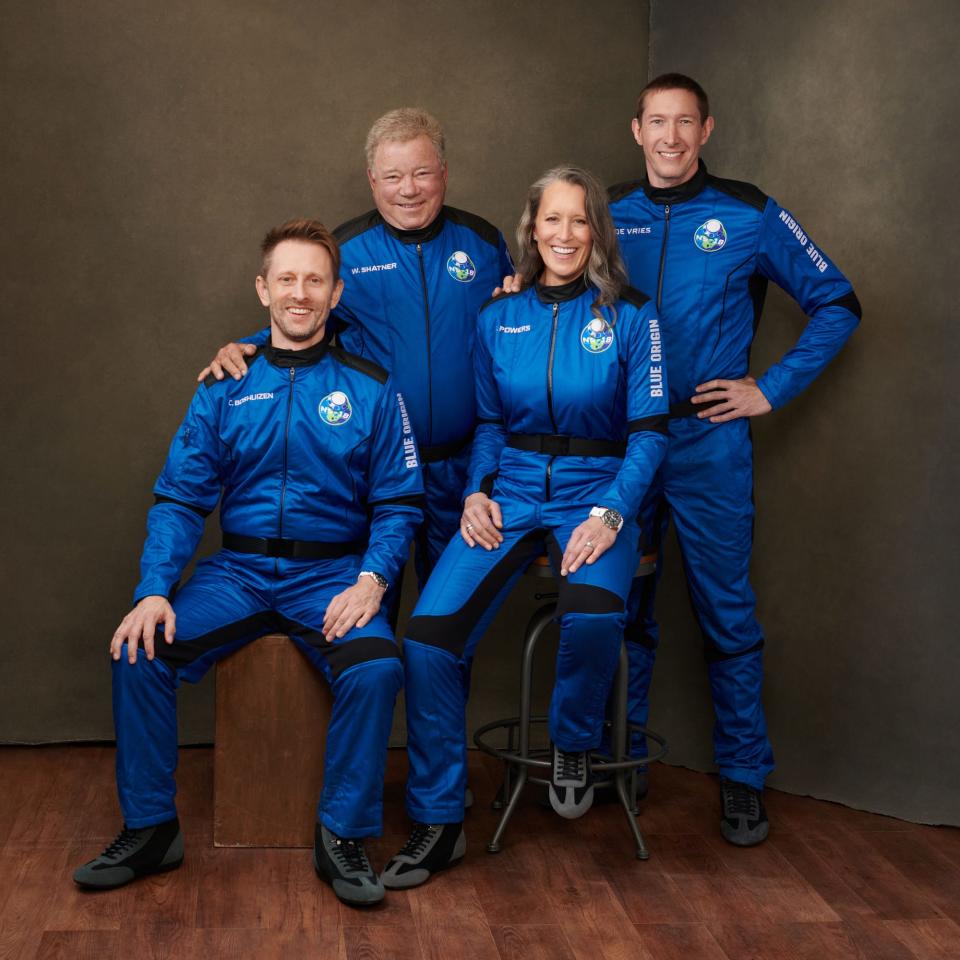 Chris Boshuizen, William Shatner, Audrey Powers, and Glen de Vries in blue space jumpsuits