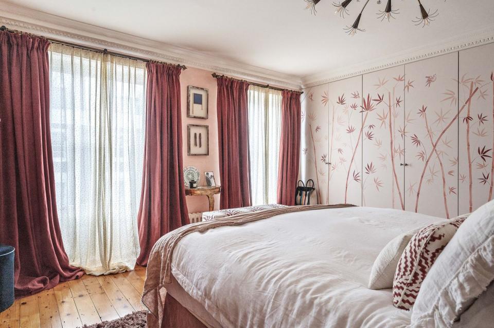 a bedroom with a bed and curtains