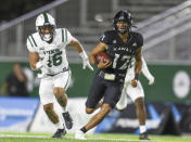 Hawaii quarterback Chevan Cordeiro (12) runs the ball as he is chased by Portland State defensive lineman Kennedy Freeman (46) during the first half of an NCAA college football game, Saturday, Sept. 4, 2021, in Honolulu. (AP Photo/Darryl Oumi)