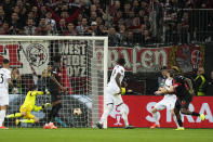 Leverkusen's Victor Boniface, right, scores his side's second goal during the Europa League quarterfinals first leg soccer match between Bayer 04 Leverkusen and West Ham United at the BayArena in Leverkusen, Germany, Thursday, April 11, 2024. (AP Photo/Martin Meissner)
