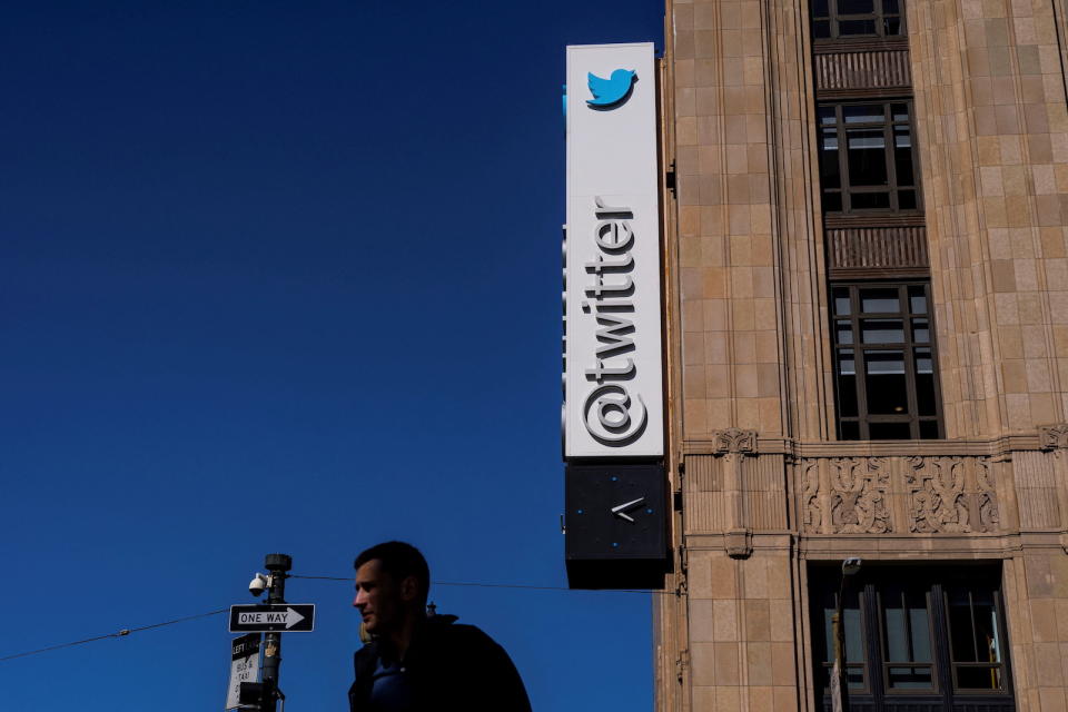 A man walks by a Twitter logo at the companyâ€™s headquarters in downtown San Francisco, California, U.S., April 25, 2022. REUTERS/Carlos Barria