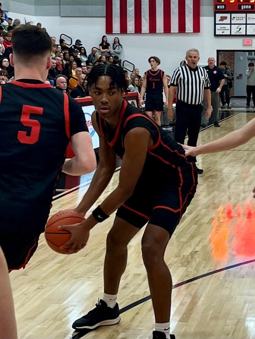 Marion Harding's Marquis Long Jr. takes an inbound pass from Parker Iden during a Mid Ohio Athletic Conference boys basketball game at Pleasant Thursday.