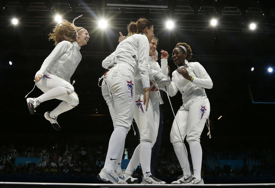 (L-R) Susie Scanlan Kelley Hurley, Courtney Hurley and Maya Lawrence of the U.S. celebrate their victory at the end of the women's eppe team bronze medal fencing competition against Russia at the ExCel venue during the London 2012 Olympic Games August 4, 2012. REUTERS/Damir Sagolj (BRITAIN - Tags: OLYMPICS SPORT FENCING TPX IMAGES OF THE DAY)