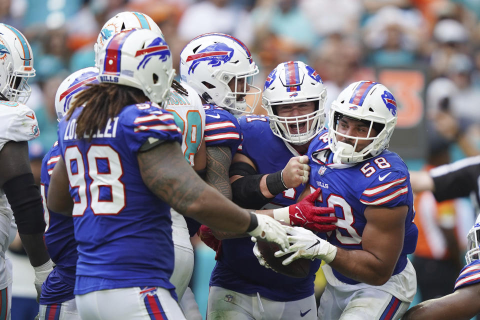 Buffalo Bills teammates celebrate outside linebacker Matt Milano (58) after Milano recovered a fumble during the first half of an NFL football game against the Miami Dolphins, Sunday, Sept. 19, 2021, in Miami Gardens, Fla. (AP Photo/Hans Deryk)