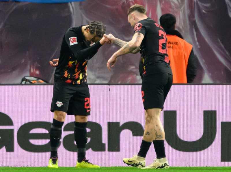 Leipzig's Xavi Simons (L) celebrates scoring his side's first goal with teammate David Raum during the German Bundesliga soccer match between RB Leipzig and Borussia Moenchengladbach at Red Bull Arena. Robert Michael/dpa