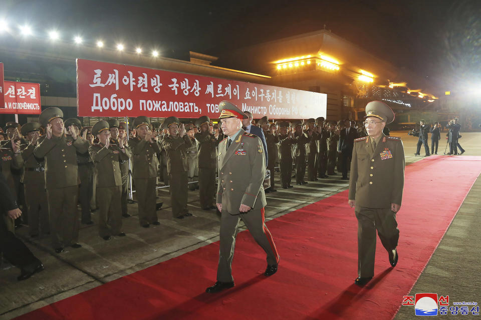 In this photo provided by the North Korean government, Russian Defense Minister Sergei Shoigu, center, is welcomed by Korean People's Army members at the Pyongyang International Airport in Pyongyang, North Korea Tuesday, July 25, 2023. Independent journalists were not given access to cover the event depicted in this image distributed by the North Korean government. The content of this image is as provided and cannot be independently verified. Korean language watermark on image as provided by source reads: "KCNA" which is the abbreviation for Korean Central News Agency. A banner means “We passionately welcome comrade Sergei Shoigu, defense minister of the Russian federation.” (Korean Central News Agency/Korea News Service via AP)