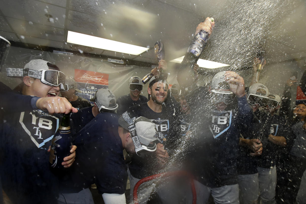 Tampa Bay Rays players celebrate after defeating the Oakland Athletics in an American League wild-card baseball game in Oakland, Calif., Wednesday, Oct. 2, 2019. (AP Photo/Jeff Chiu)