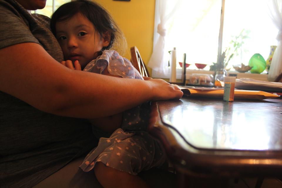 A woman who asked to be identified only by her first name, Ingrid, holds her 3-year-old daughter on Aug. 22, 2019. Ingrid's husband and his sister were detained during immigration raids in Mississippi on Aug. 7, 2019. Now Ingrid is the sole caretaker of nine children — six of them her own, three of them belonging to her sister-in-law, a single mother.