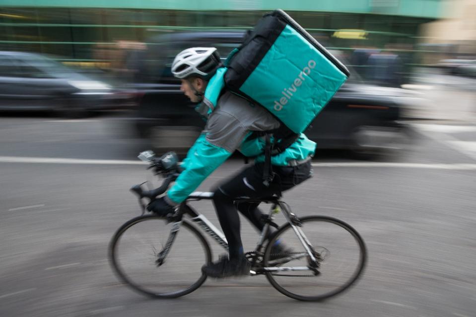A Deliveroo rider speeds through London. MPs say such gig economy workers deserve better rights (AFP Photo/Daniel Leal-Olivas)