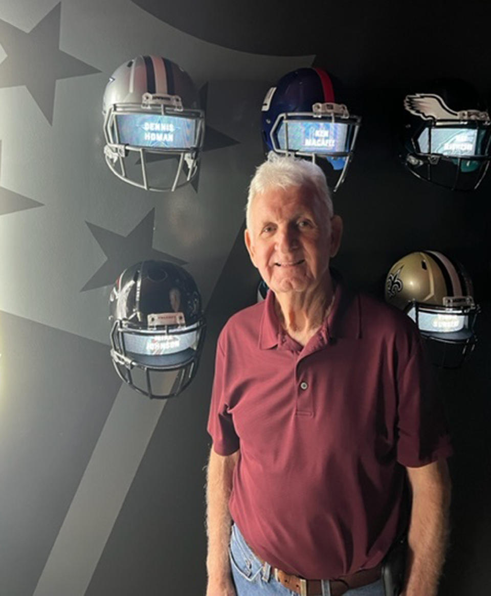 Former Alabama split end Dennis Homan, who was on the 1965 team, poses while touring a museum at the University of Alabama with his family in Tuscaloosa, Ala. Homan's grandson, current Alabama long snapper Kneeland Hibbett, has pledged to donate a share of his name, image and likeness proceeds to the Concussion Legacy Foundation, which has worked with ex-football players and others who developed traumatic brain injuries from repeated hits to the head. (Homan family photograph via AP)