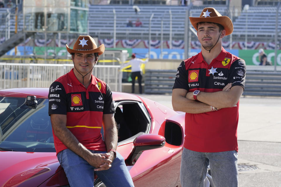 Ferrari driver Carlos Sainz, left, of Spain, and Ferrari driver Charles Leclerc, of Monaco, pose for a photo at the Formula One U.S. Grand Prix auto race at Circuit of the Americas, Thursday, Oct. 20, 2022, in Austin, Texas. (AP Photo/Darron Cummings)