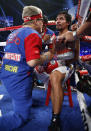 Manny Pacquiao, right of the Philippines, talks with trainer Freddie Roach during a WBO welterweight title boxing fight against Timothy Bradley on Saturday, April 12, 2014, in Las Vegas. (AP Photo/Eric Jamison)