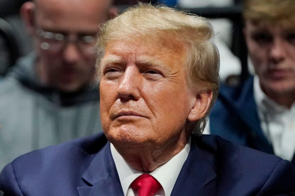 Former President Donald Trump watches the NCAA Wrestling Championship on March in Tulsa, Okla. Trump’s calls for protests ahead of his anticipated indictment in New York have generated mostly muted reactions from supporters, with even some of his most ardent loyalists dismissing the idea as a waste of time or a law enforcement trap.