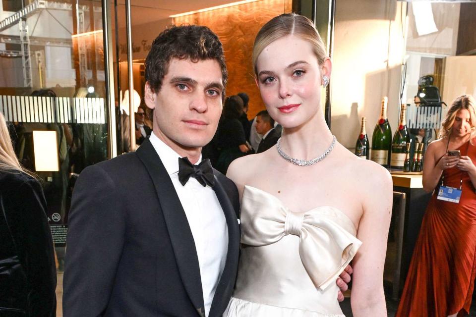 <p>Michael Kovac/Getty</p> Gus Wenner and Elle Fanning at the Golden Globe Awards in Los Angeles on Jan. 7, 2024