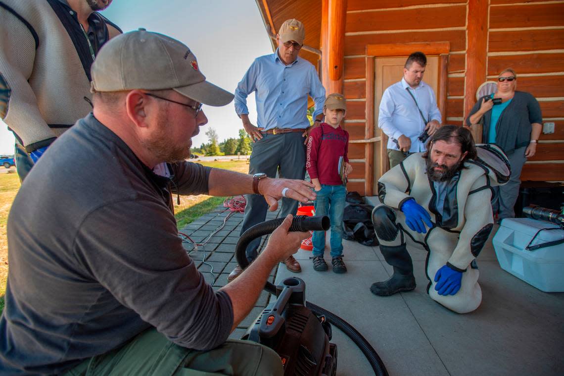 Washington Gov. Jay Inslee, center, watches Washington State Department of Agriculture entomologist Sven-Erik Spichiger, left, describe the specialized equipment used to catch live giant Asian hornets (Vespa mandarinia) during a training session held by the agriculture department at Birch Bay State Park on Tuesday morning July 12, in Blaine, Wash. Personnel from the agency demonstrated the various ways in which they capture and track the invasive species and how citizens can help by identifying and reporting the insects.