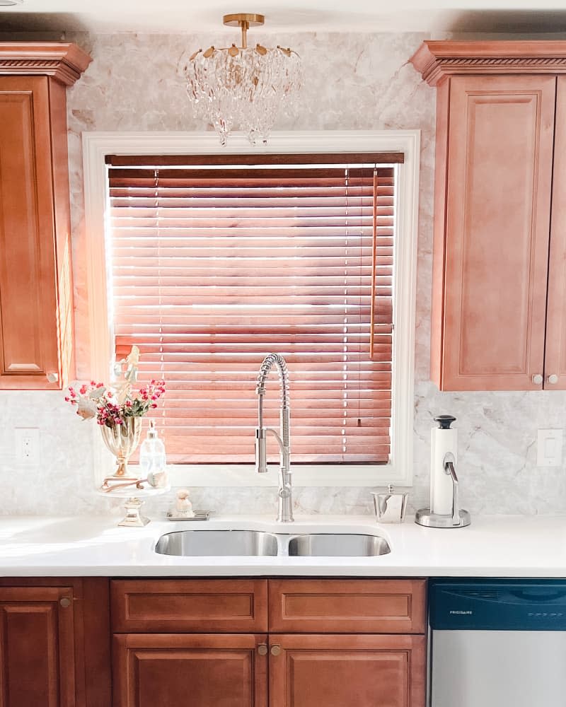 Marbled wallpaper in white countertops in newly remodeled kitchen.