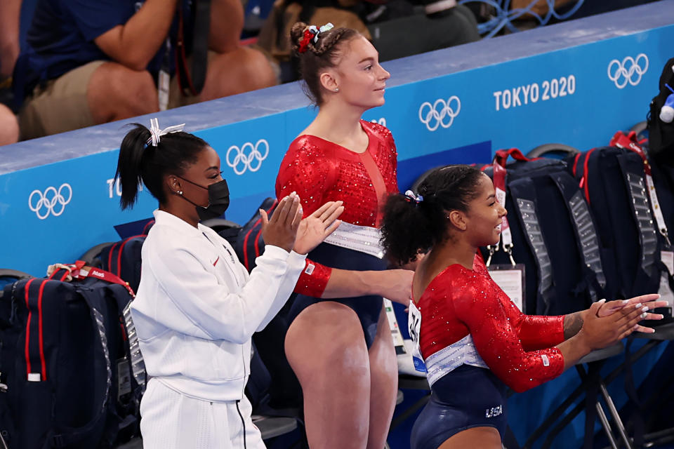 TOKYO, JAPAN - JULY 27: (L-R) Simone Biles, Grace McCallum, and Jordan Chiles cheer for Sunisa Lee of Team United States (not pictured) as she competes on uneven bars during the Women's Team Final on day four of the Tokyo 2020 Olympic Games at Ariake Gymnastics Centre on July 27, 2021 in Tokyo, Japan. (Photo by Jamie Squire/Getty Images)