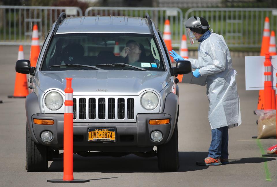 A driver gets tested for coronavirus at a drive-thru site in a Walmart parking lot in Rochester, N.Y., on May 5.