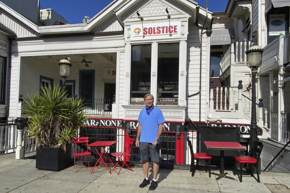 Johnny Metheny stands outside Solstice, a restaurant that he closed last year because pandemic dining restrictions made it too difficult to stay in business,in San Francisco on Feb. 13, 2021. Metheny owns three other restaurants in the city, and two are temporarily closed. The pandemic has forced thousands of restaurants to permanently shut their doors as dining restrictions keep customers away. But the unprecedented closures have created a business boom for commercial auctioneers that buy and sell used restaurant equipment. (AP Photo/Terry Chea)