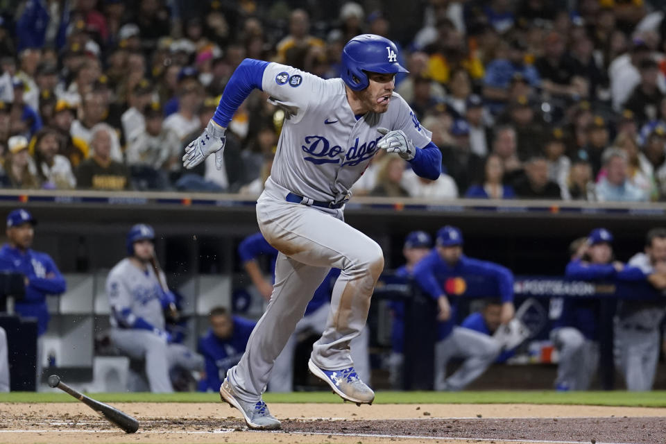 Los Angeles Dodgers' Freddie Freeman watches his two-run double during the third inning in Game 4 of a baseball NL Division Series against the San Diego Padres, Saturday, Oct. 15, 2022, in San Diego. The Dodgers' Mookie Betts and Trea Turner scored on the play. (AP Photo/Ashley Landis)