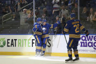 Buffalo Sabres center Drake Caggiula, center, celebrates with defenseman Will Butcher, left, after scoring a goal during the second period of an NHL hockey game against the Tampa Bay Lightning, Monday, Oct. 25, 2021, in Buffalo, N.Y. (AP Photo/Joshua Bessex)