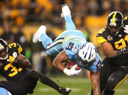 Nov 16, 2017; Pittsburgh, PA, USA; Tennessee Titans running back DeMarco Murray (29) is upended by Pittsburgh Steelers defensive back Mike Hilton (31) during the second quarter at Heinz Field. The Steelers won 40-17. Mandatory Credit: Charles LeClaire-USA TODAY Sports