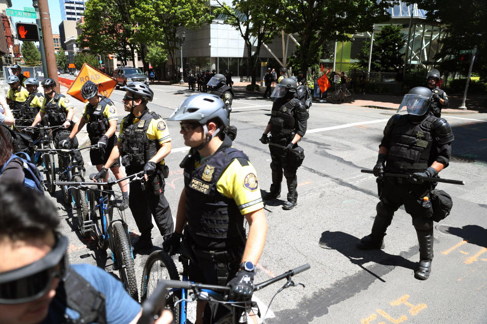 Multiple groups, including Rose City Antifa, the Proud Boys and conservative activist Haley Adams protest in downtown Portland, Ore., Saturday, June 29, 2019. (Dave Killen/The Oregonian via AP)