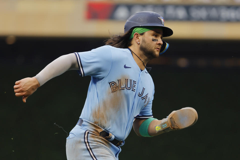 Toronto Blue Jays' Bo Bichette scores on a single from Kevin Kiermaier during the sixth inning in Game 1 of an AL wild-card baseball playoff series against the Minnesota Twins Tuesday, Oct. 3, 2023, in Minneapolis. (AP Photo/Bruce Kluckhohn)