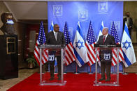 U.S. Defense Secretary Lloyd Austin, left, and Israeli Prime Minister Benjamin Netanyahu give statements after their meeting, at the prime minister's office, in Jerusalem, Monday, April 12, 2021. (Menahem Kahana/Pool via AP)